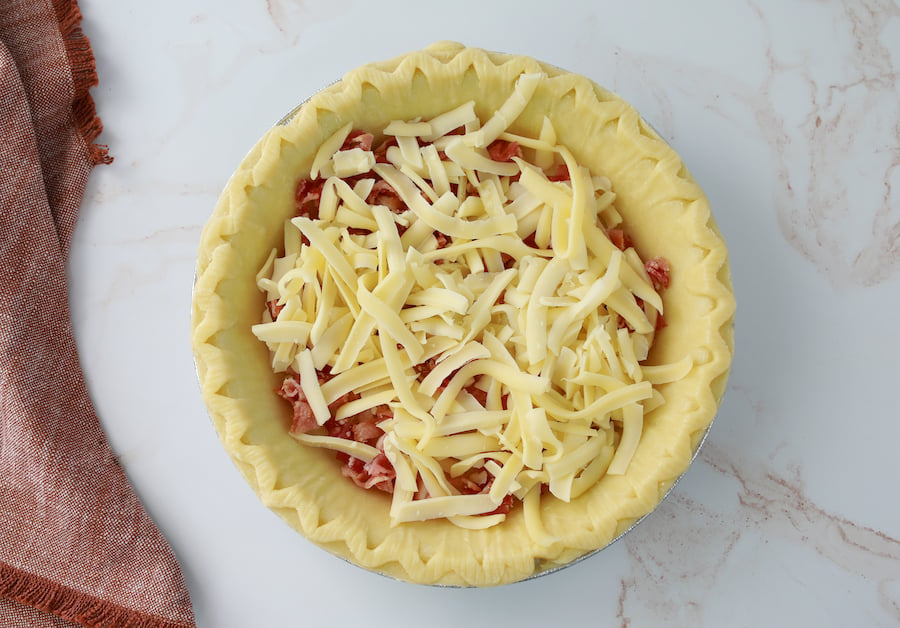 filling pie crust with meat and cheese