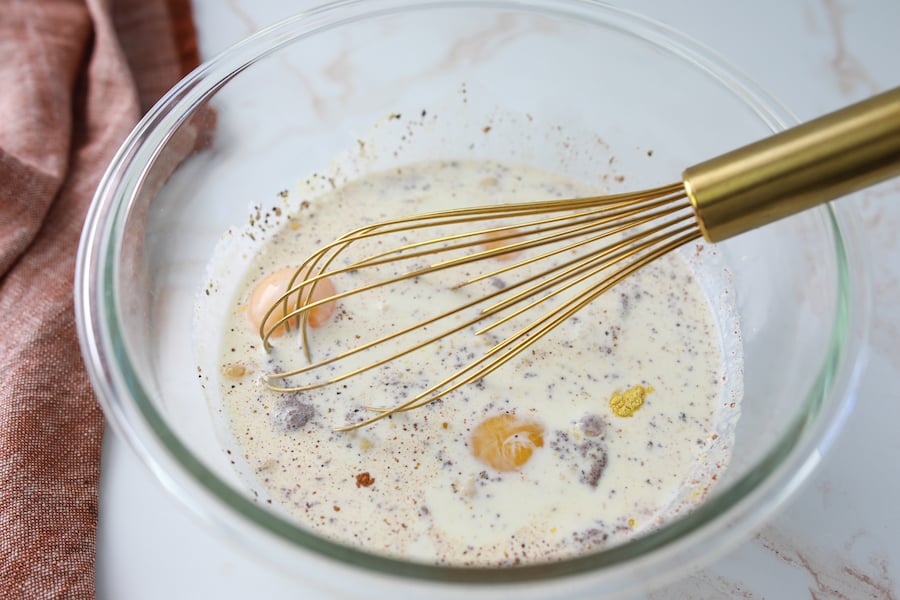 mixing eggs and other ingredients in large bowl with whisk