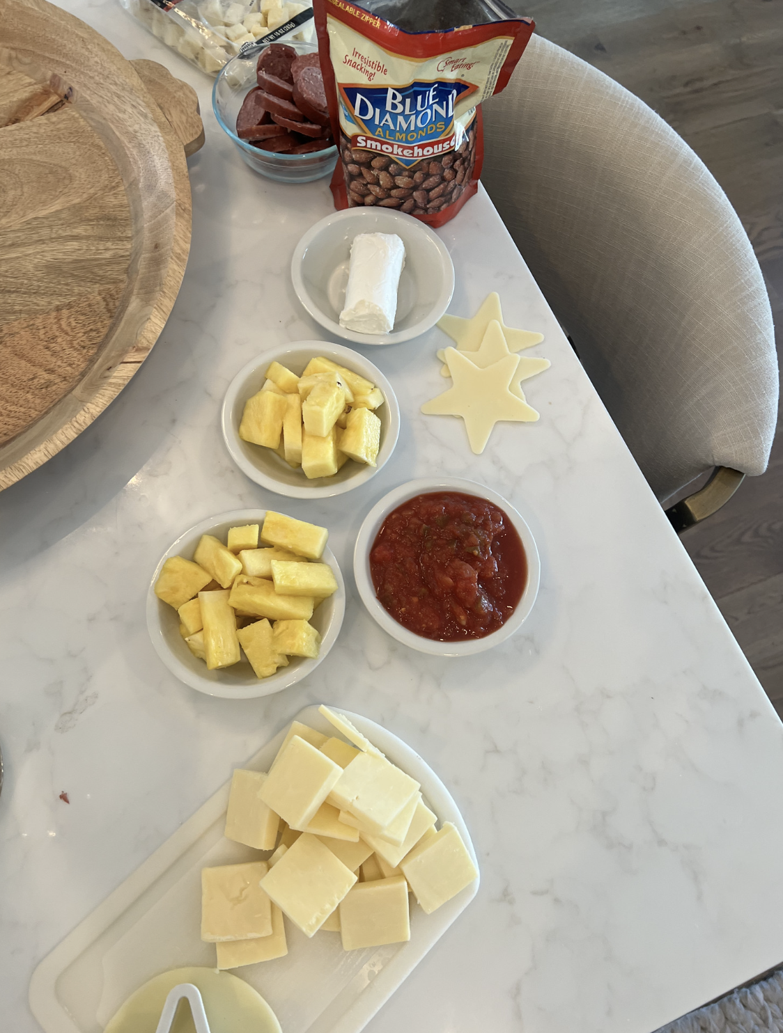 items for charcuterie on counter in white bowls 