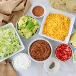 layered tex mex ingredients in white bowls