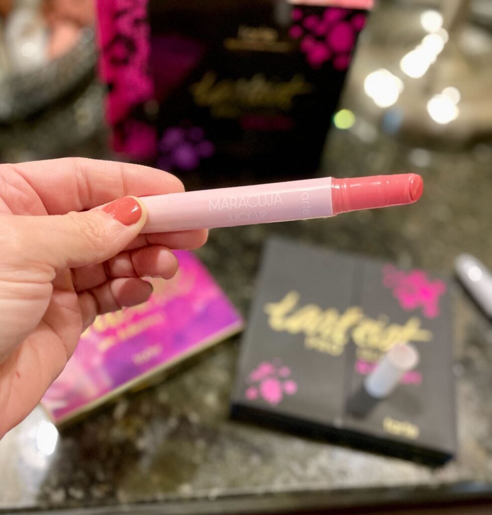 person holding tarte cosmetics