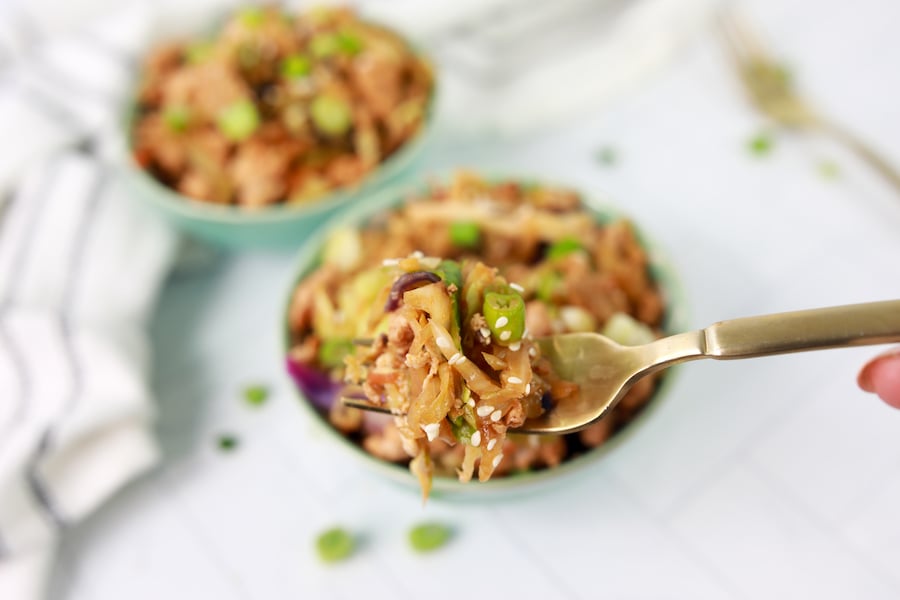 close up view of egg roll in a bowl with ground turkey on fork