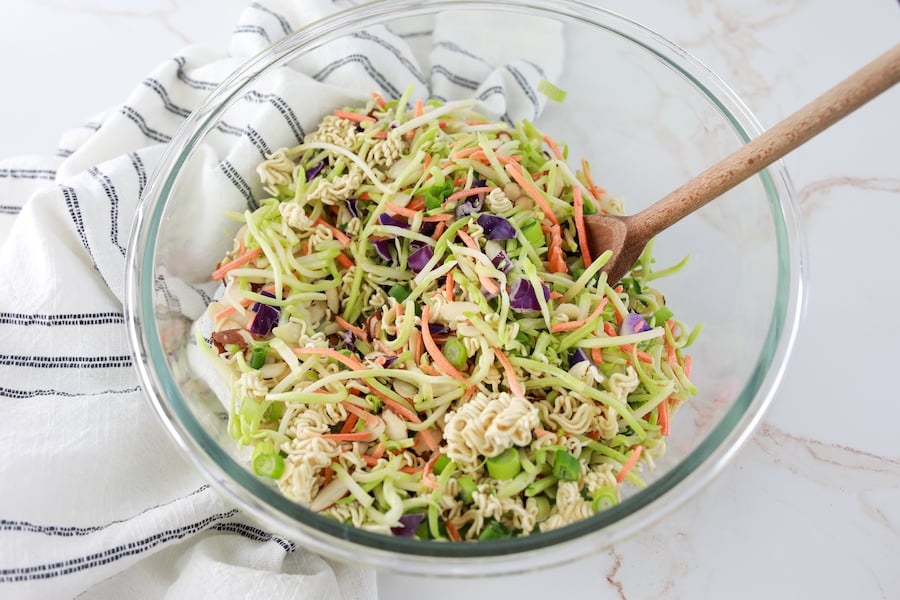 broccoli slaw in mixing bowl with spoon