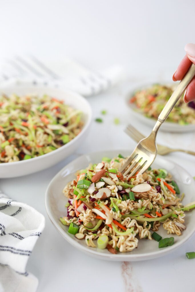 broccoli slaw on white plates with fork