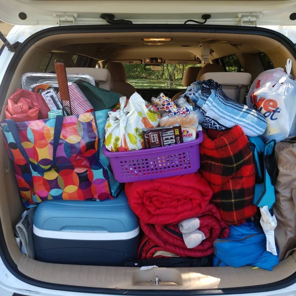 trunk of suv packed with items for camping
