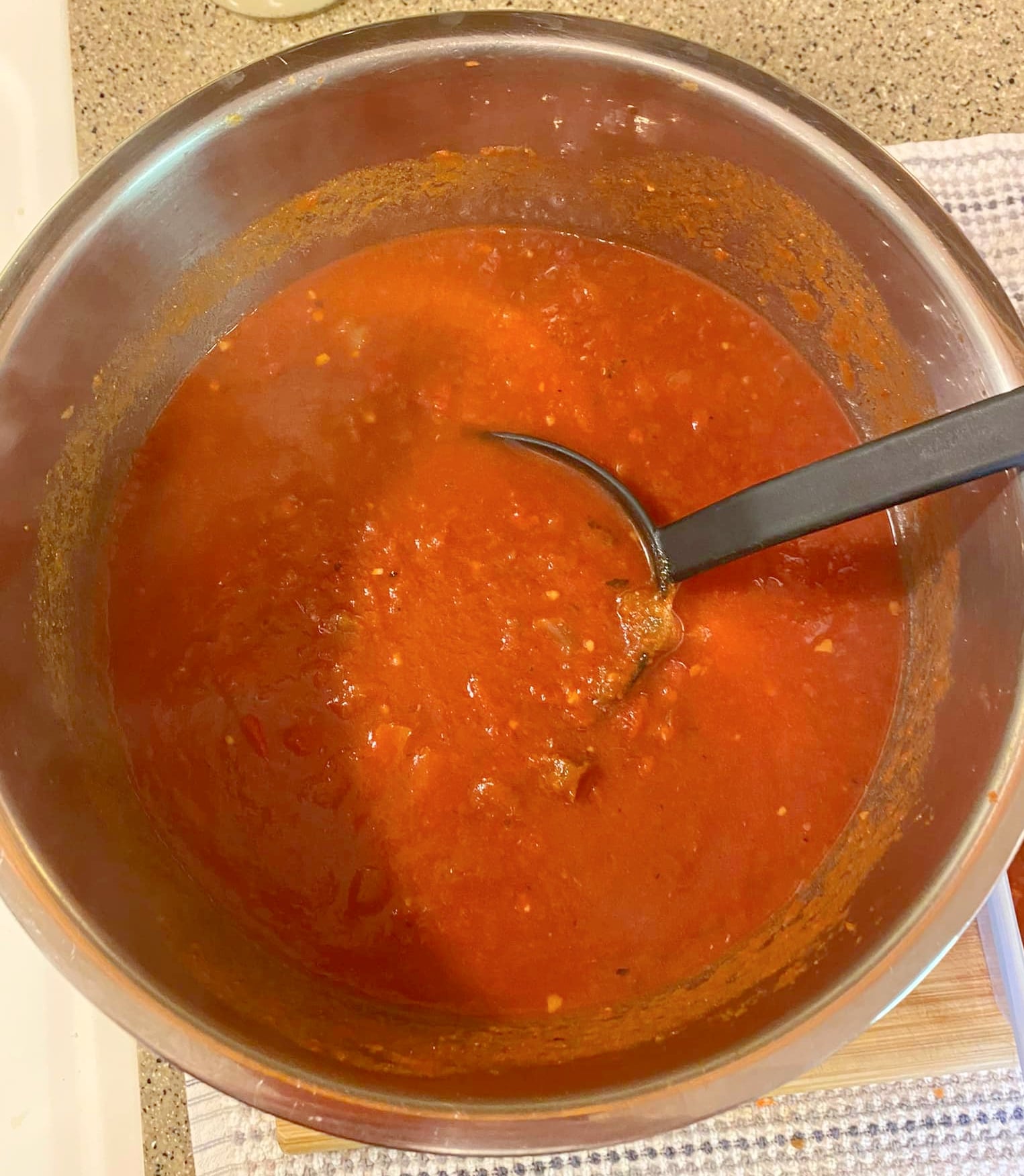 creamy tomato soup finished cooking with ladle