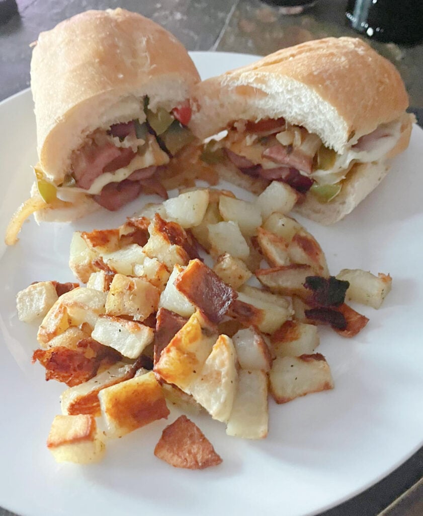 country fried potatoes on plate with sandwich