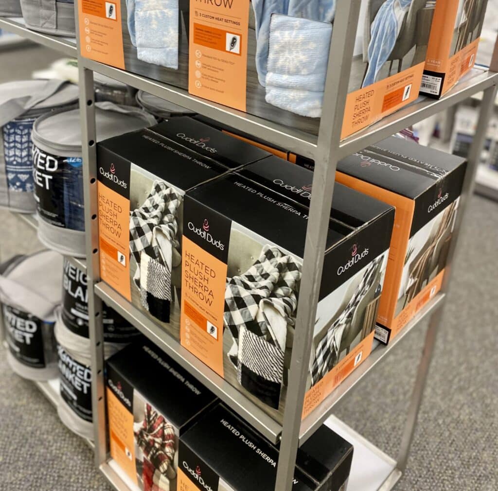 shelf in store filled with cuddl duds throw blankets