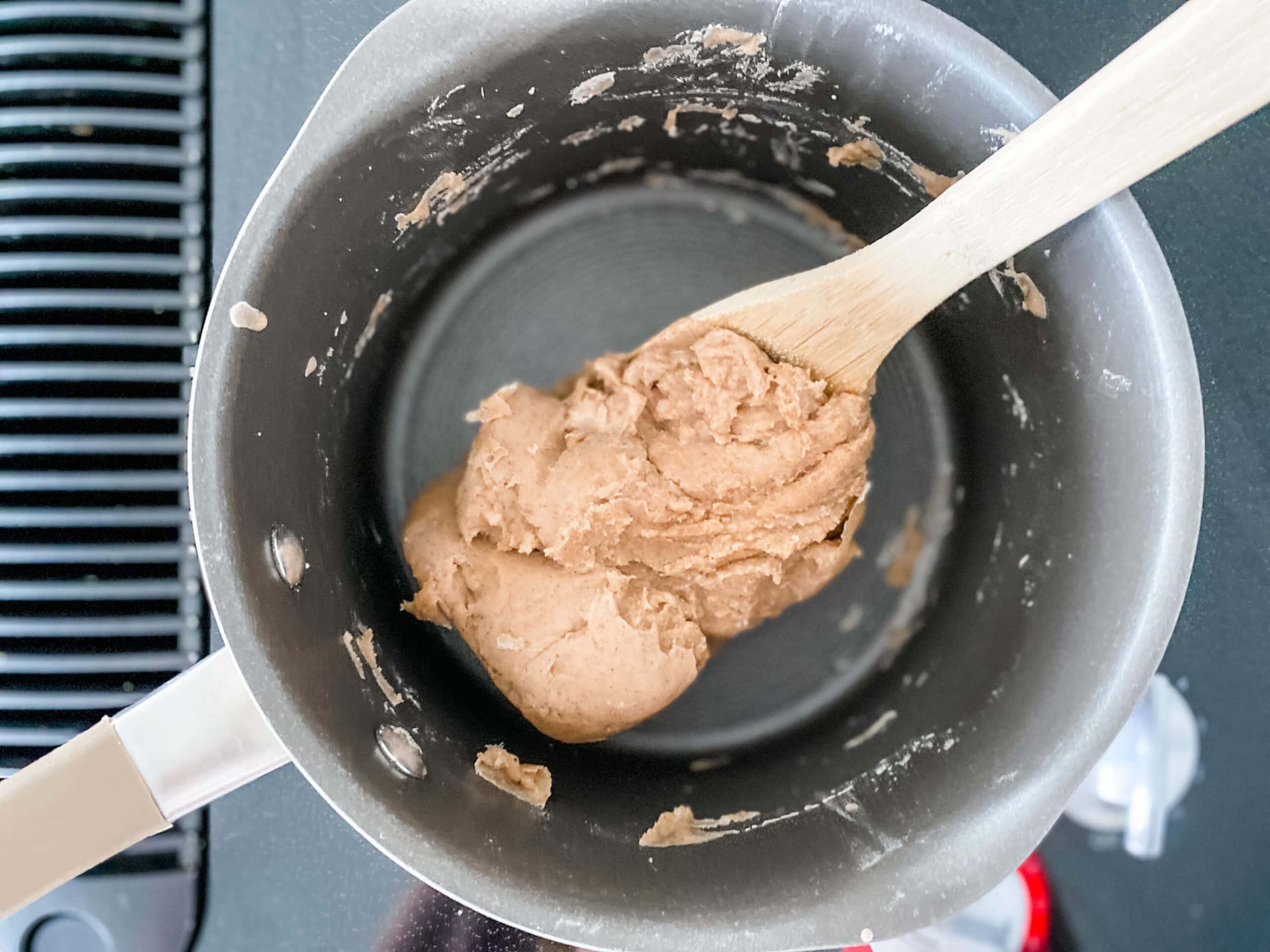 making homemade gingerbread play dough on the stove 