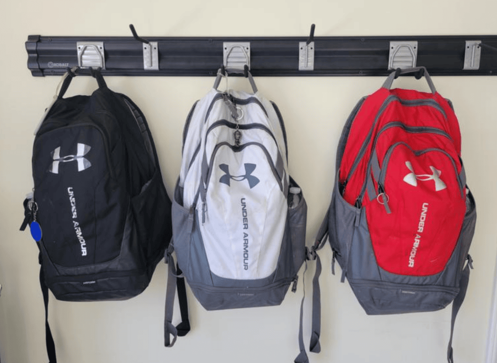 3 under armour backpacks hanging up
