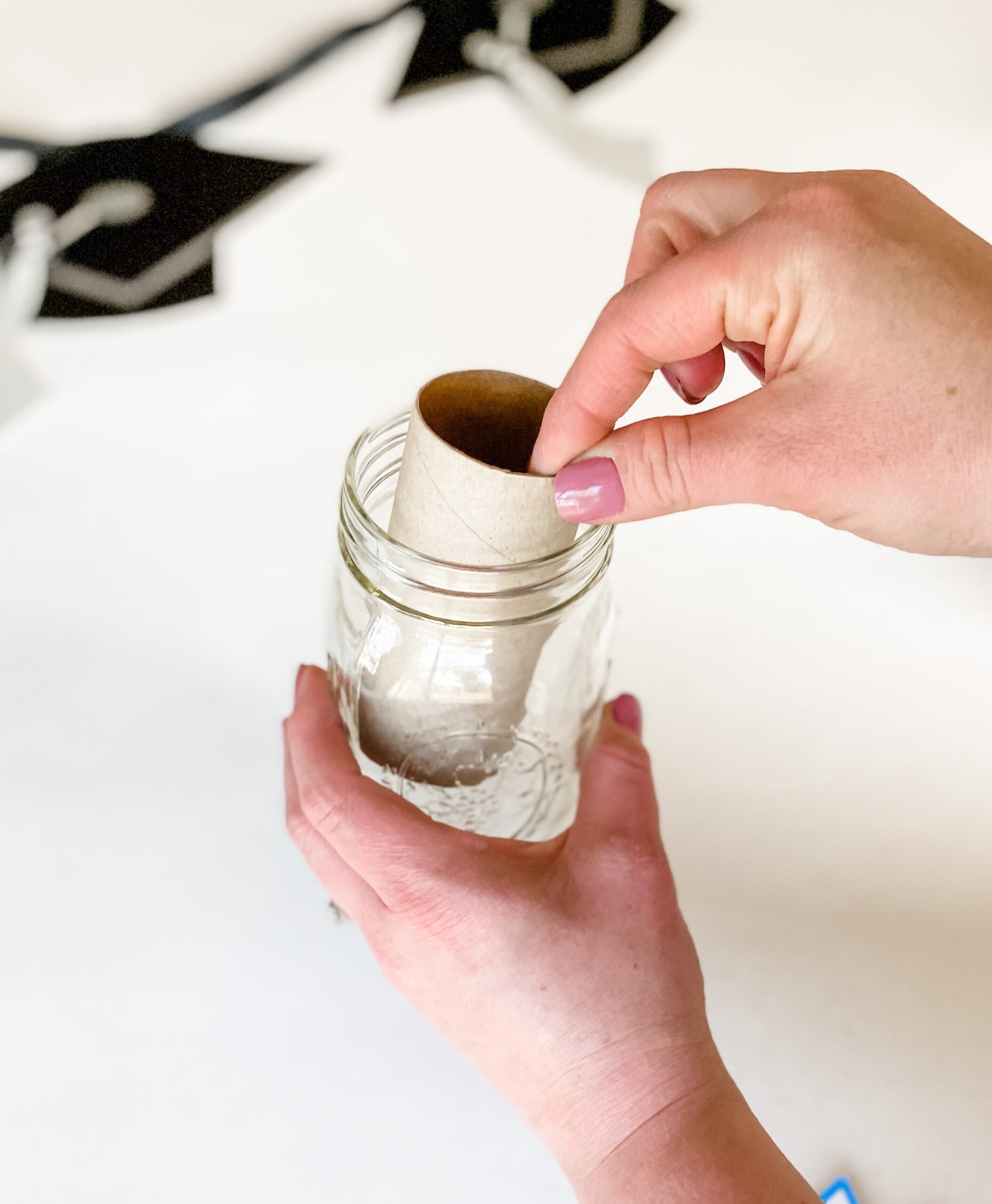 putting toilet paper roll into candy jar to hide cash 