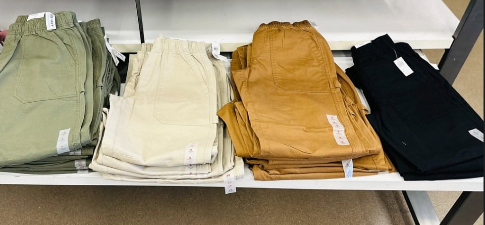 folded cargo pants on display in store