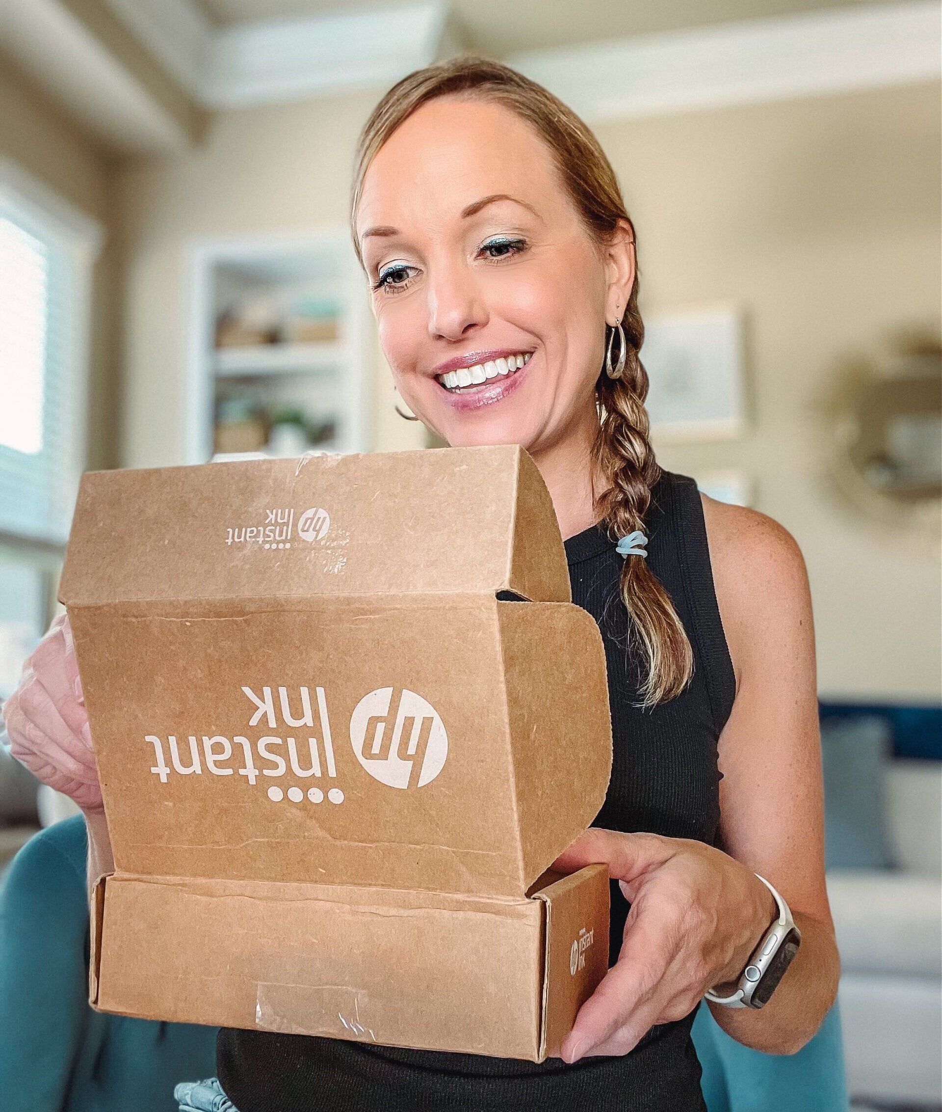hp instant ink woman holding cardboard box and smiling