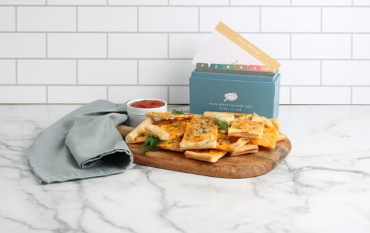 Cheesy Flatbread finished on platter with recipe box