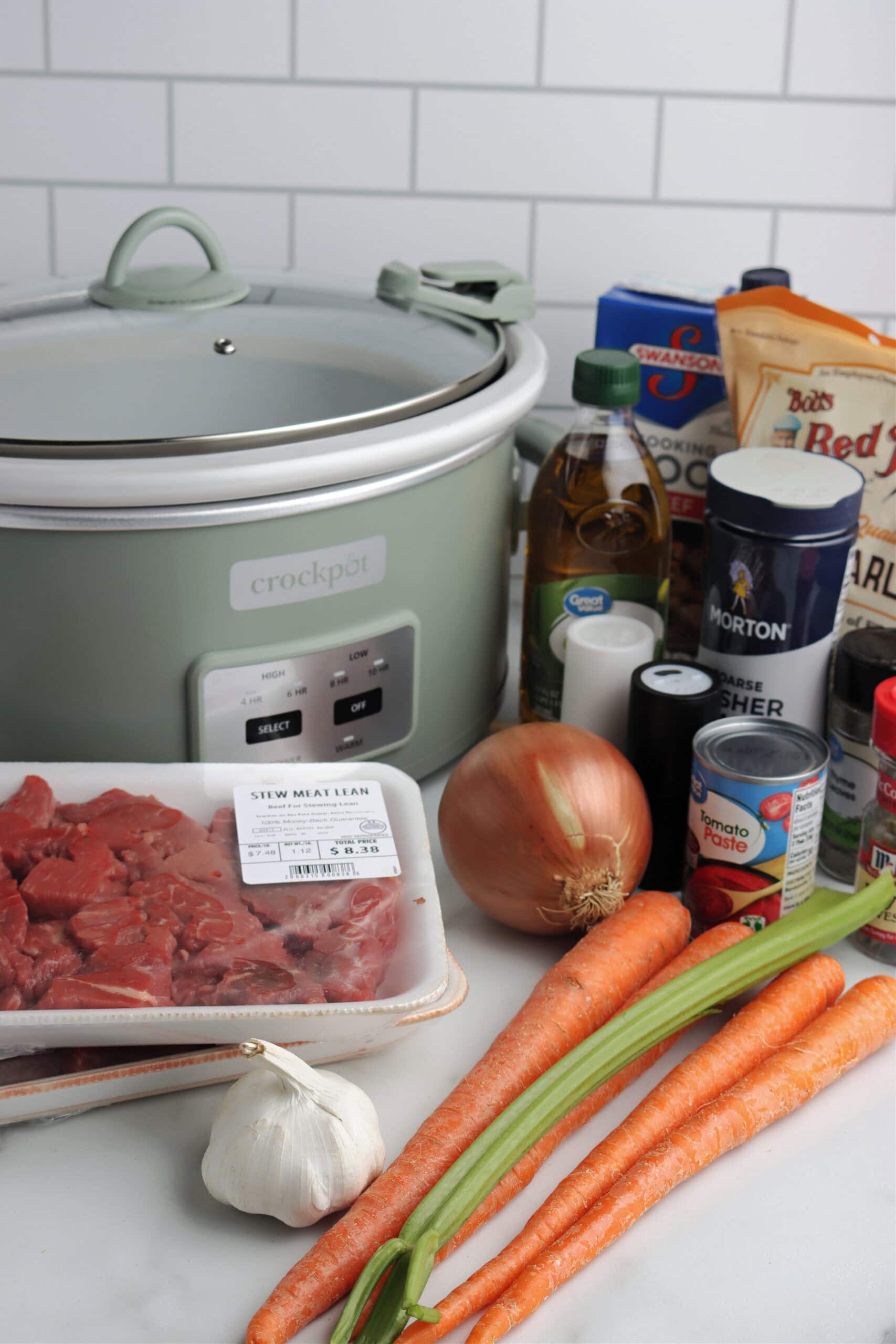 VEGETABLE BEEF AND BARLEY SOUP ingredients on countertop with slow cooker 