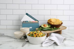 Awesome Avocado and Corn Salsa on counter with recipe box