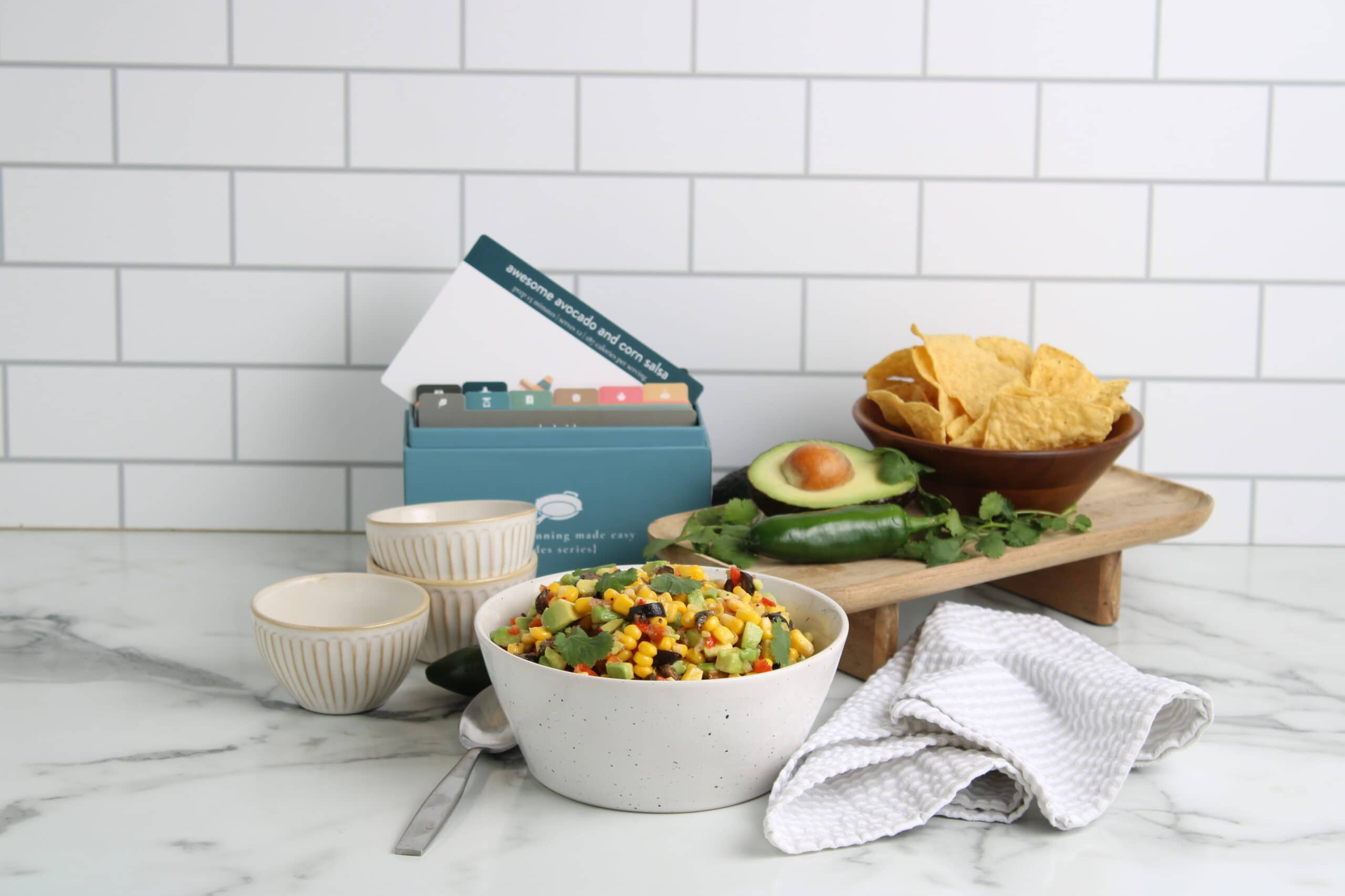 Awesome Avocado and Corn Salsa on counter with recipe box