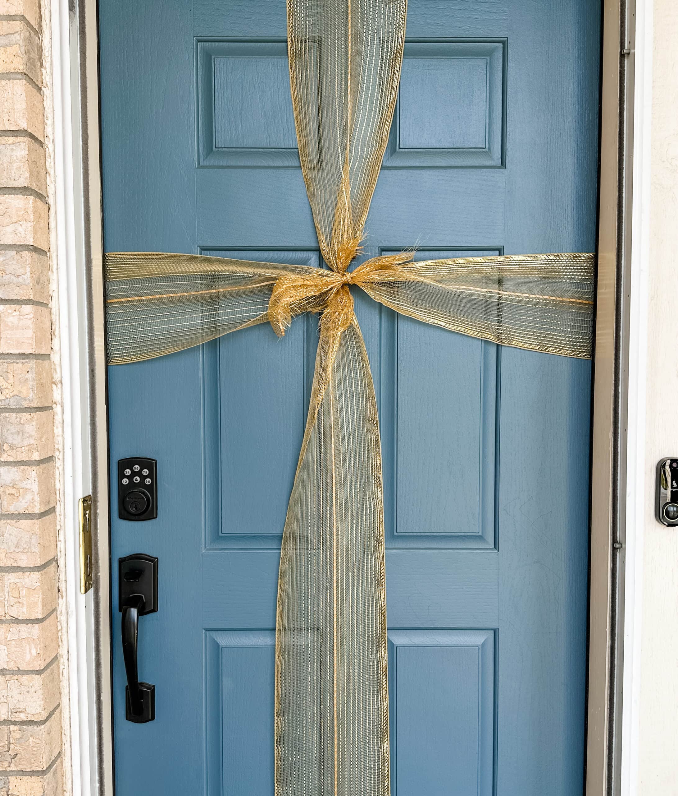 gold bow on blue door