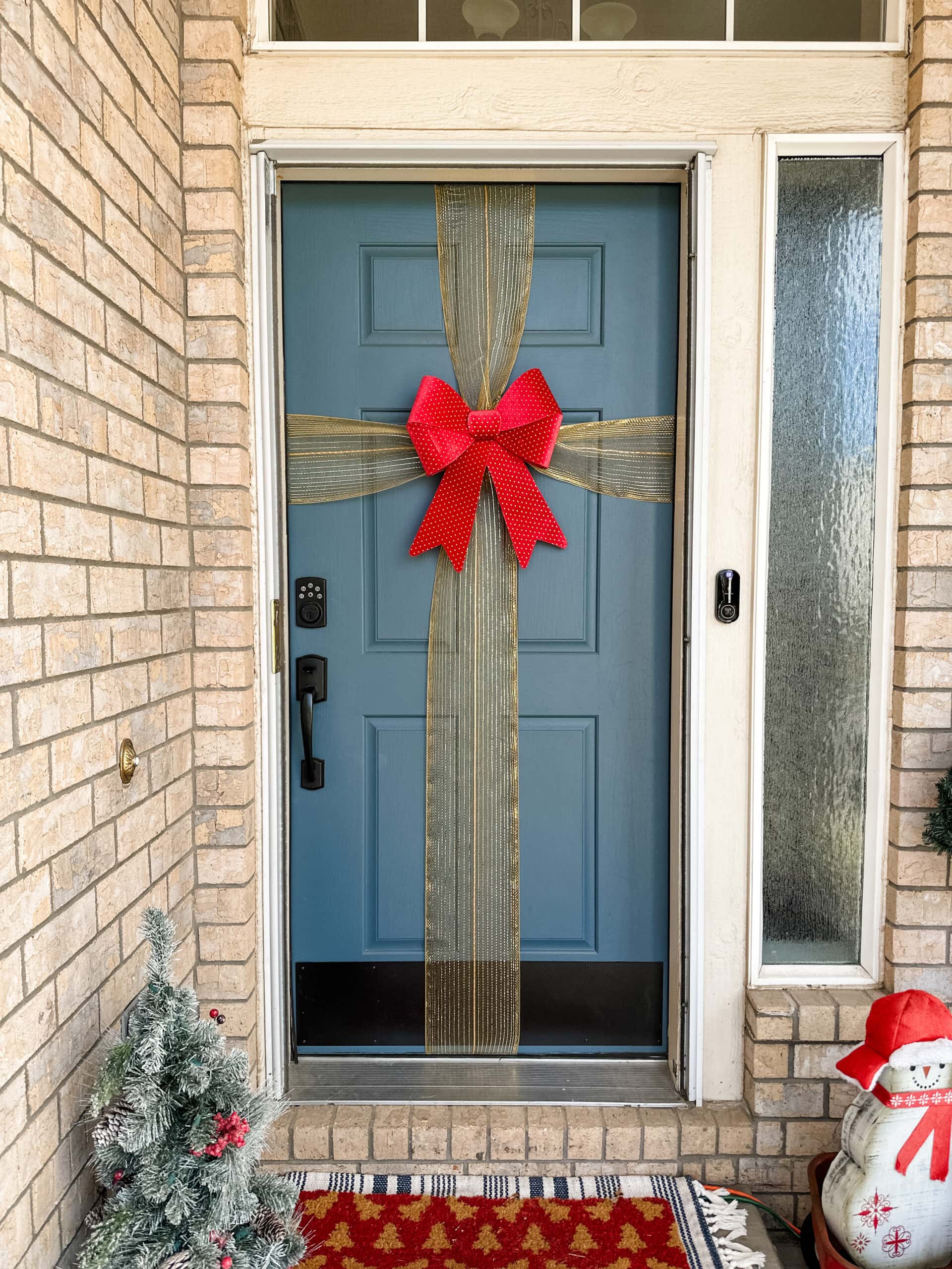finished blue door with gold ribbon and red bow 
