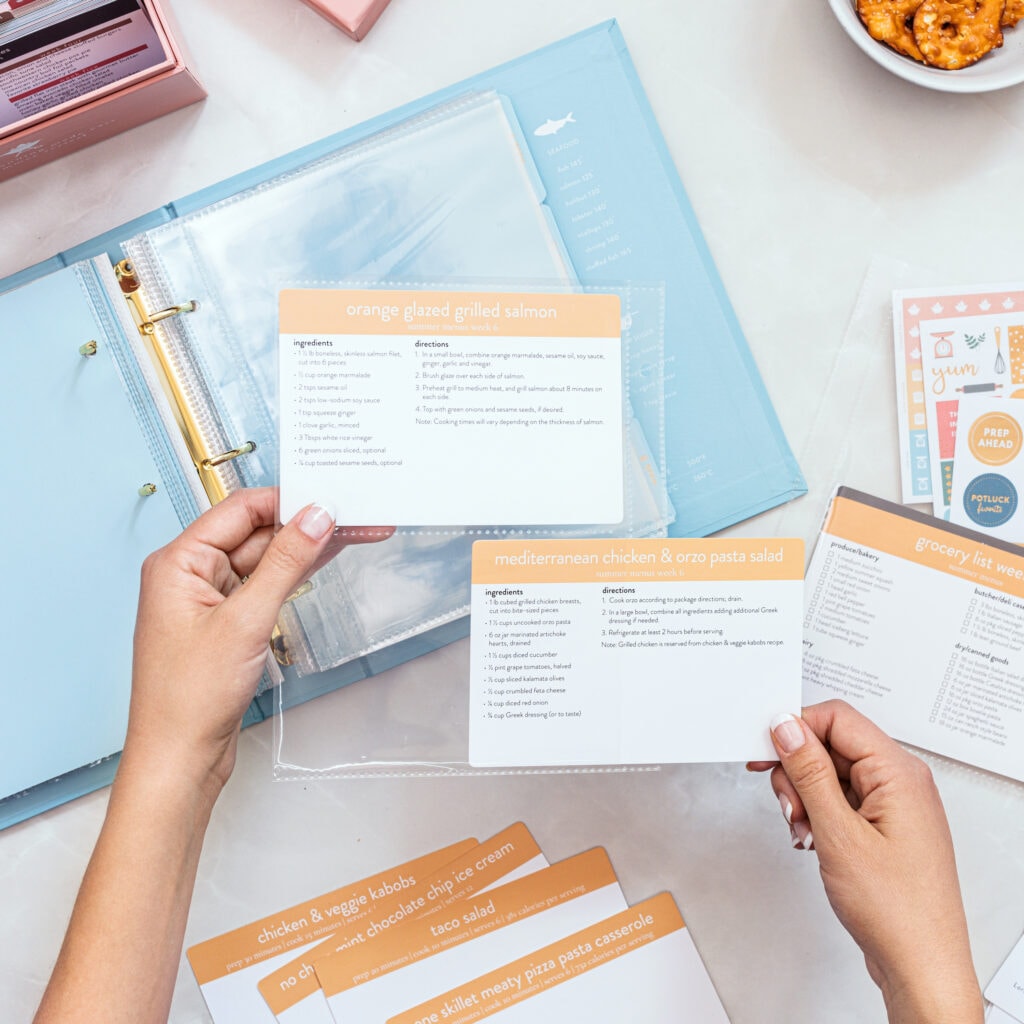 Blue recipe card binder open with 2 recipe cards inside