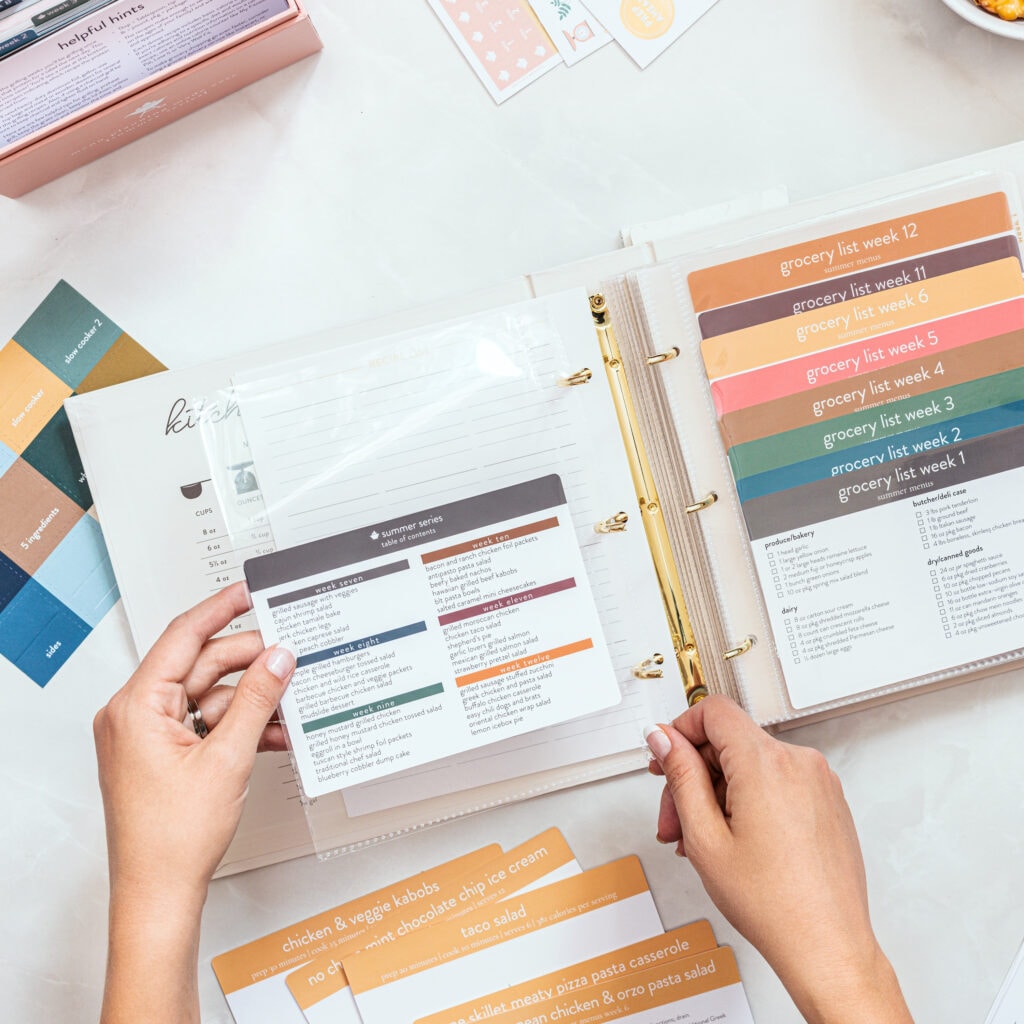 Cream recipe card binder with grocery lists showing