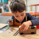 child making a truck at home depot workshop