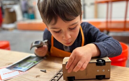 child making a truck at home depot workshop