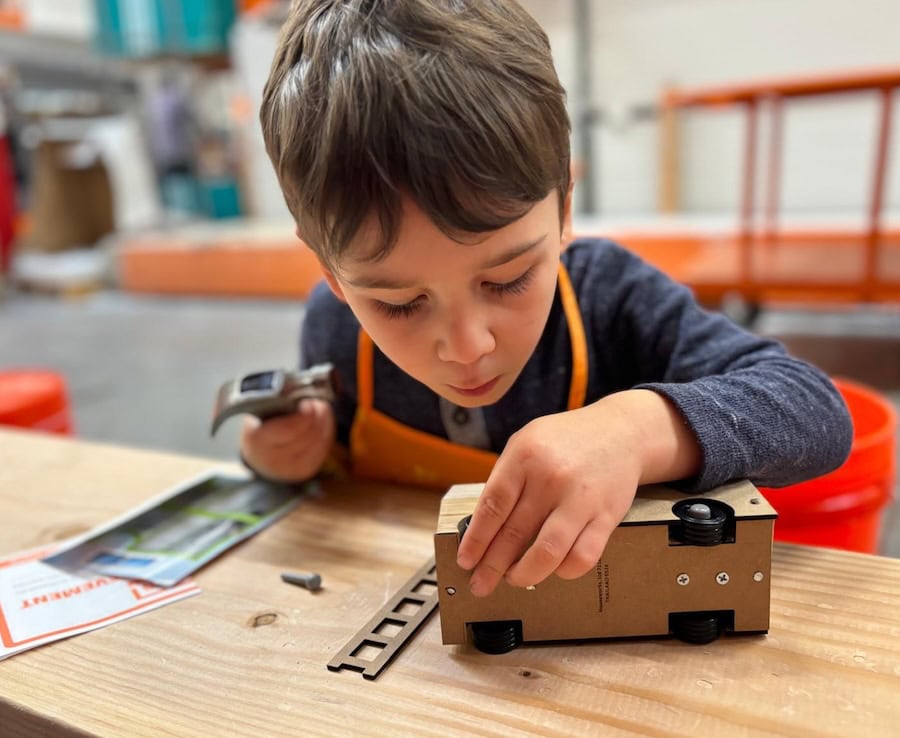 child making a truck at home depot workshop