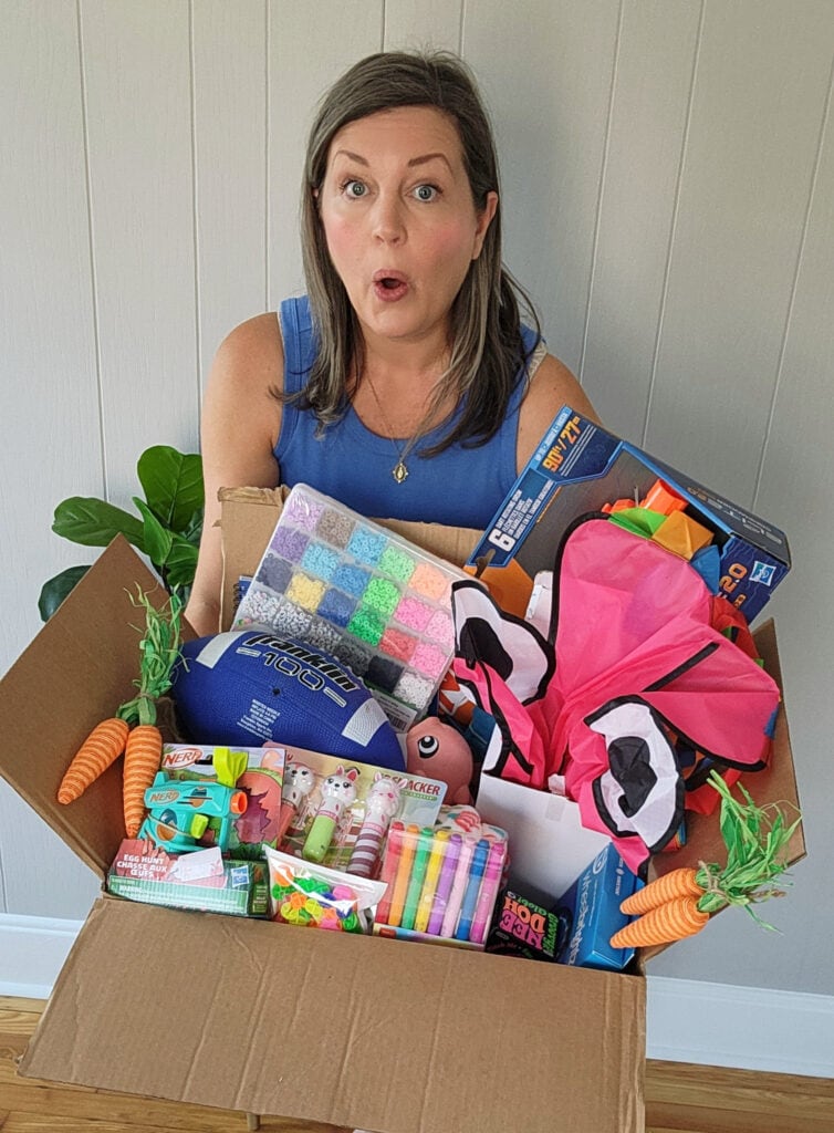 Amazon Easter Basket Stuffer Items in Large Box with Woman Holding