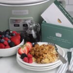 sausage and waffle bake finished on plate with fruit and recipe box