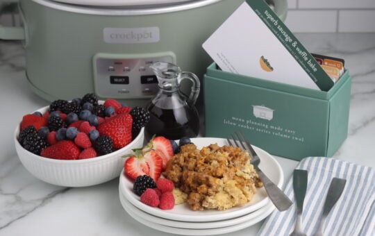 sausage and waffle bake finished on plate with fruit and recipe box