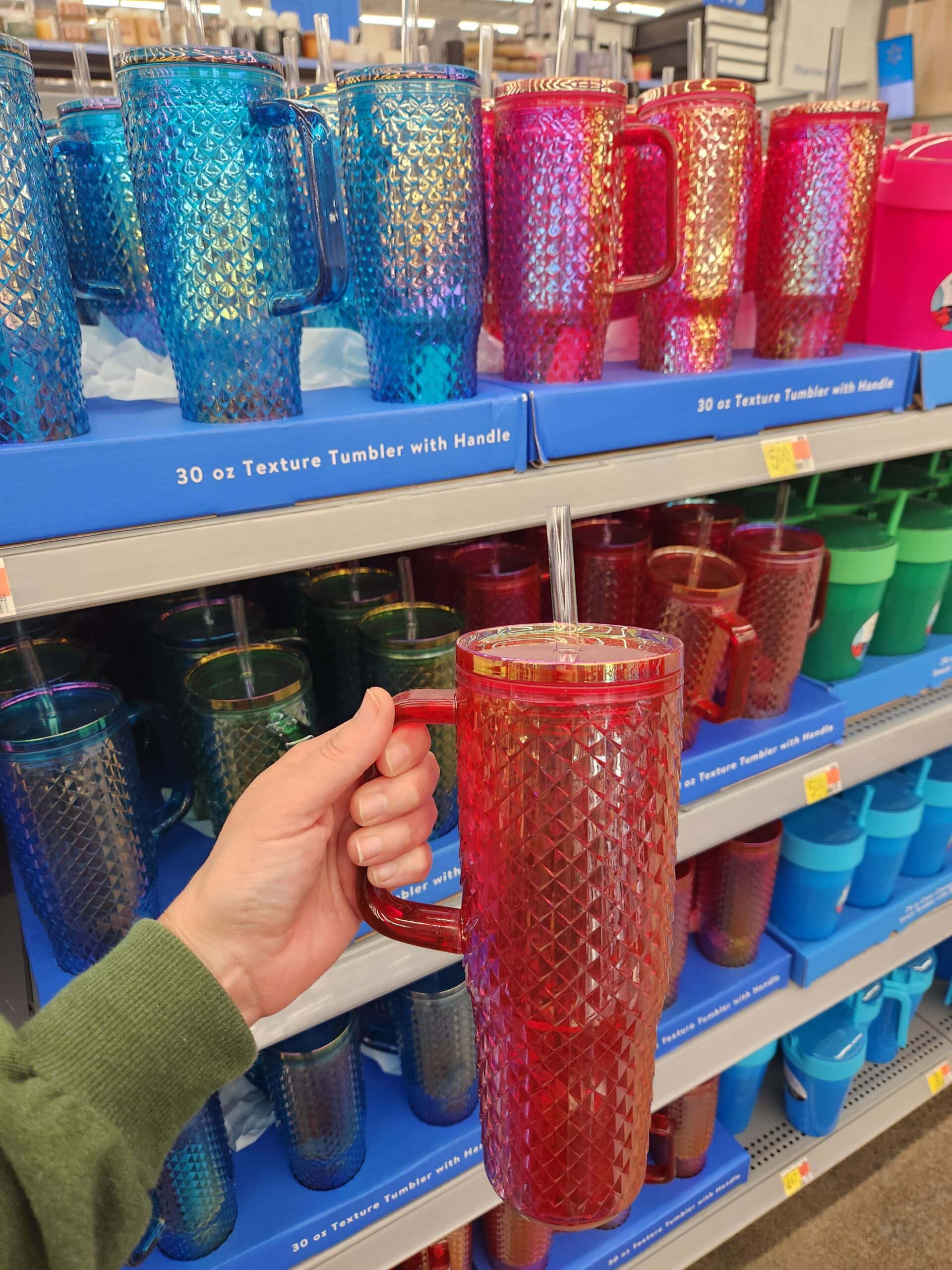 hand holding tumblers