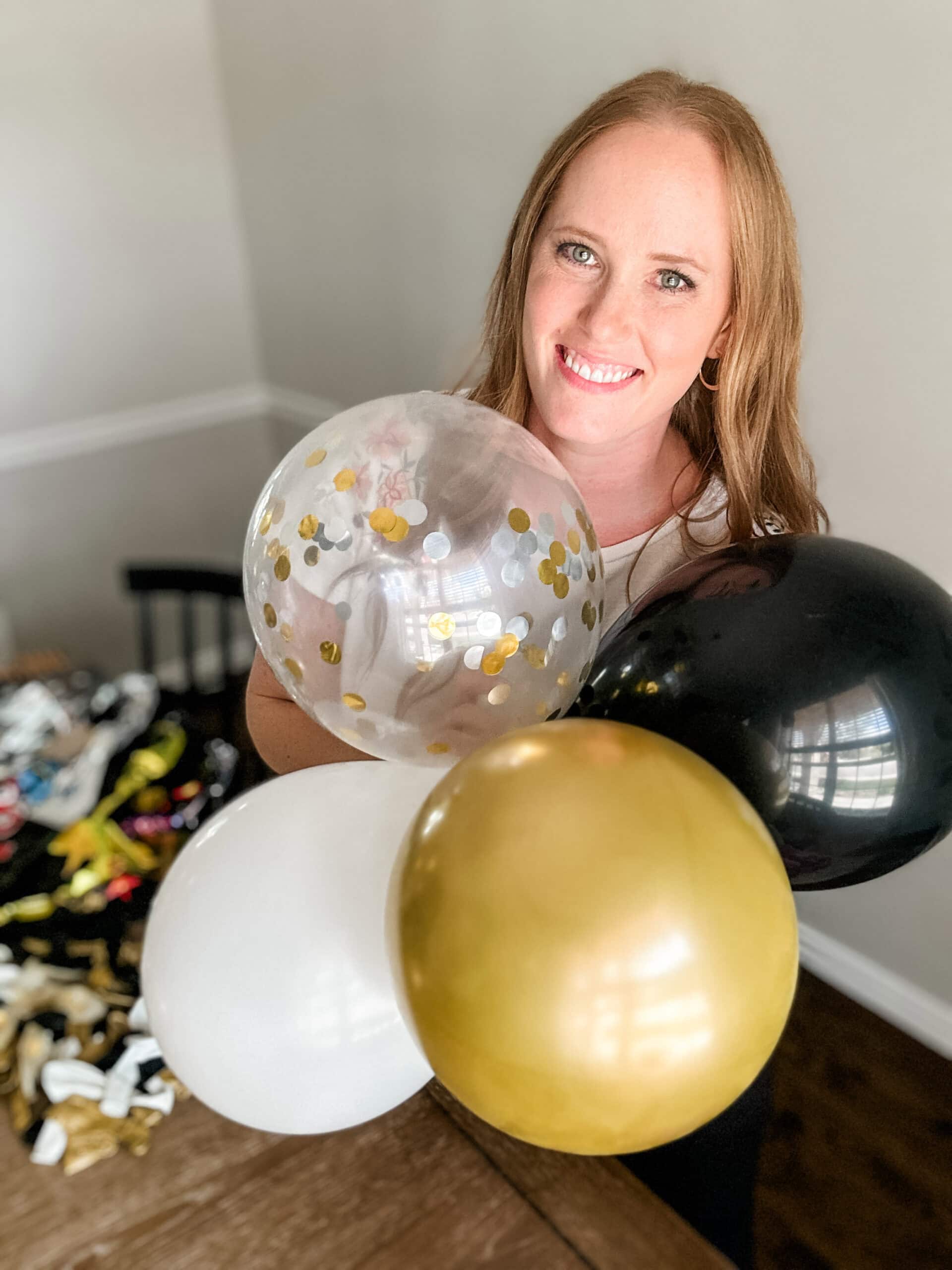 woman holding a group of balloons