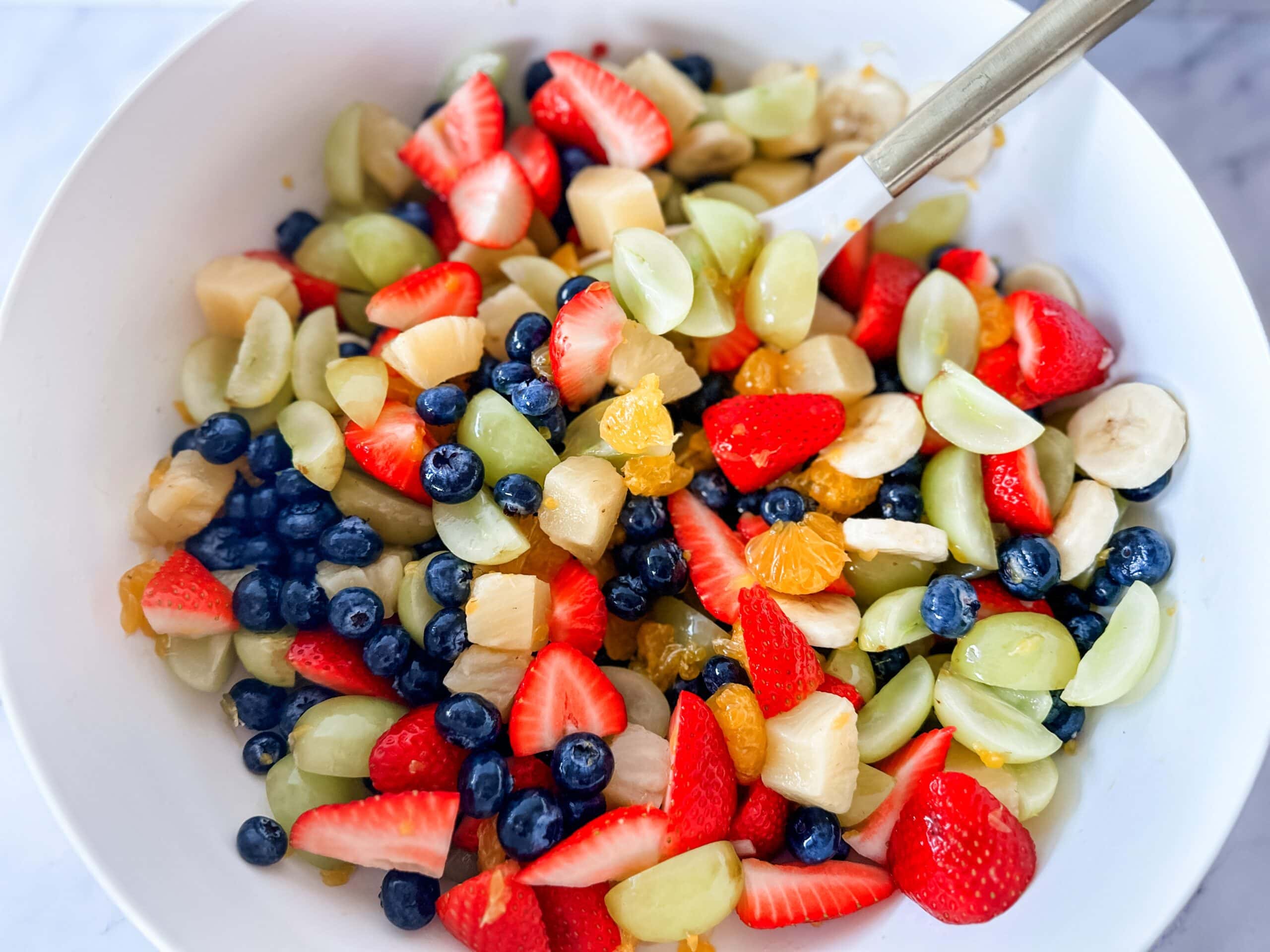 fruit salad in bowl with zesty lime dressing