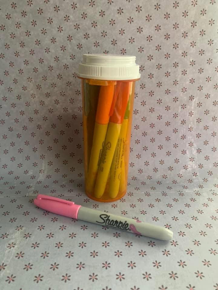 keeping sharpies organized in a large empty pill bottle