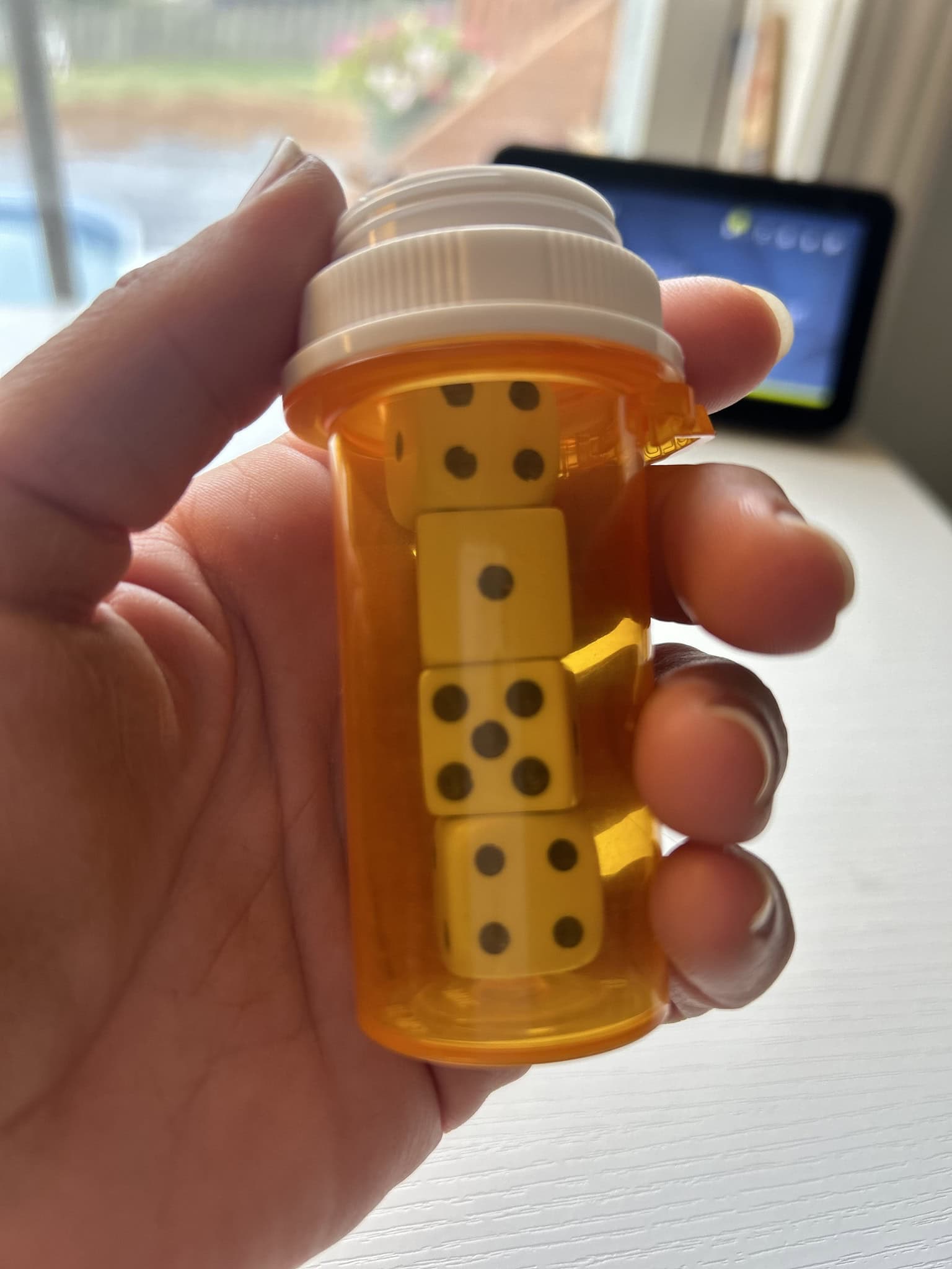 storing game pieces in empty pill bottles