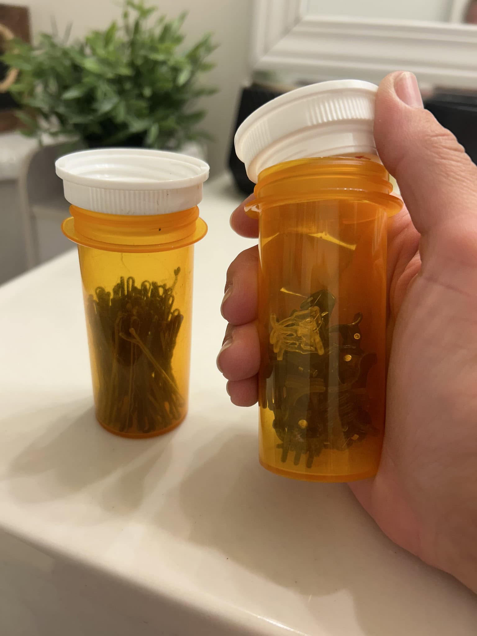 using empty pill bottles for storage of small items 