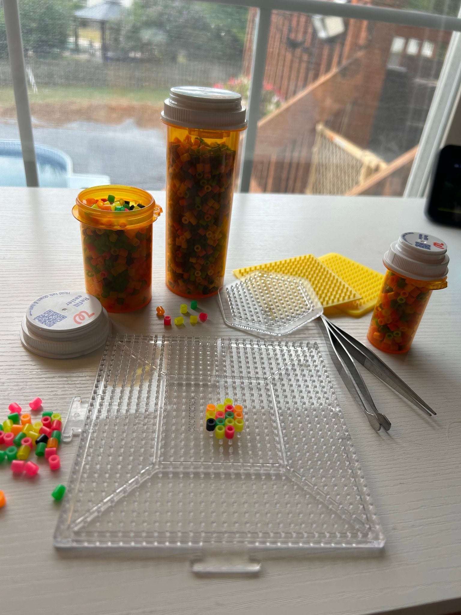 storing craft pieces in empty pill bottles
