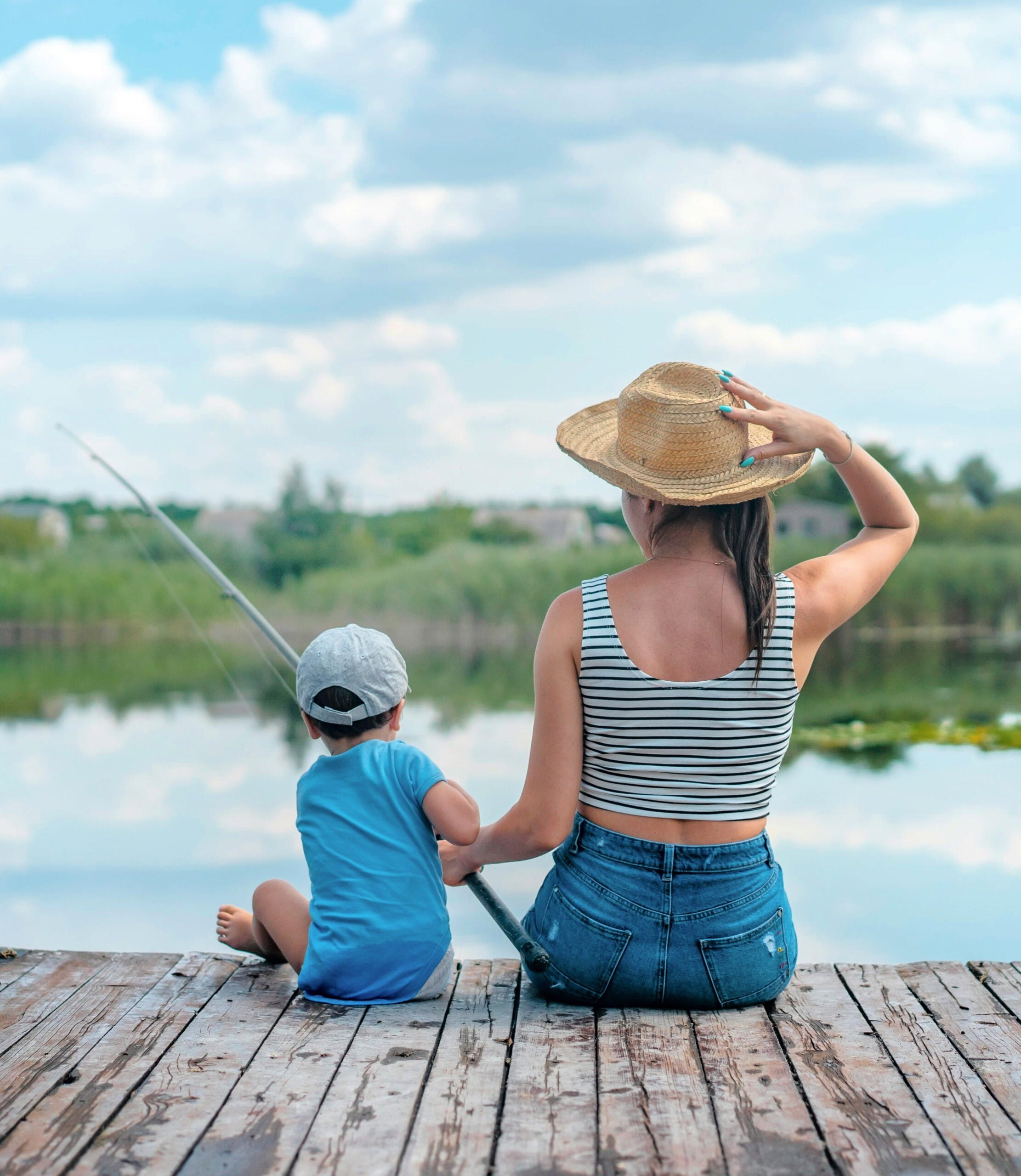 woman and son fishing on pier 