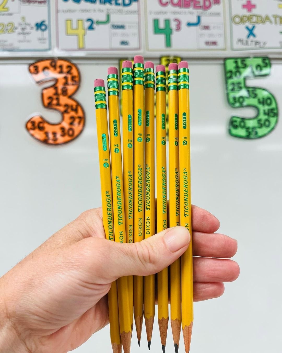 woman holding pencils