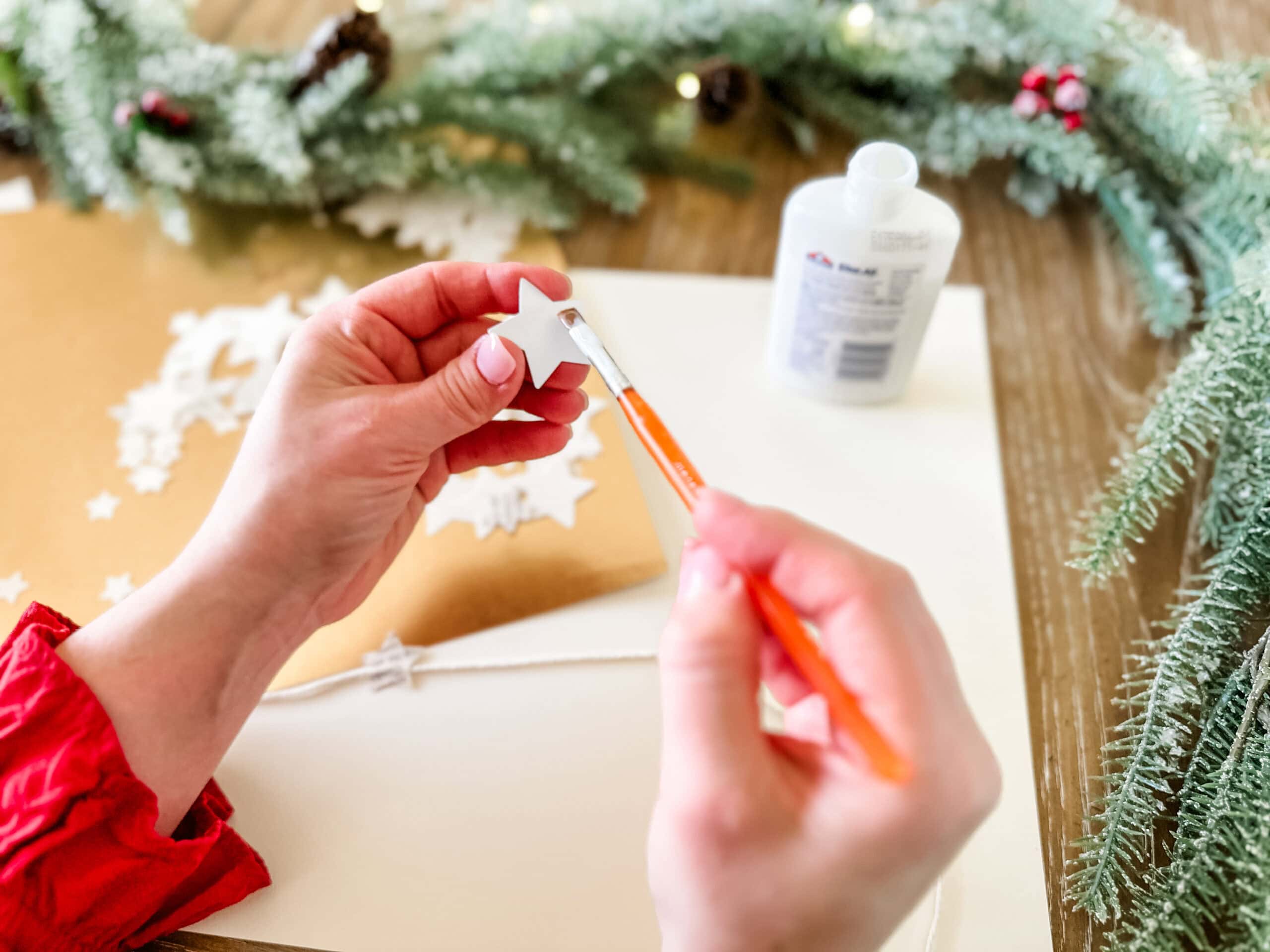 putting glue on paper stars