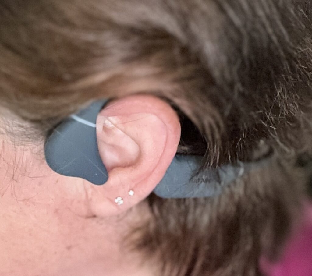 how do bone conduction headphones sit on your ear