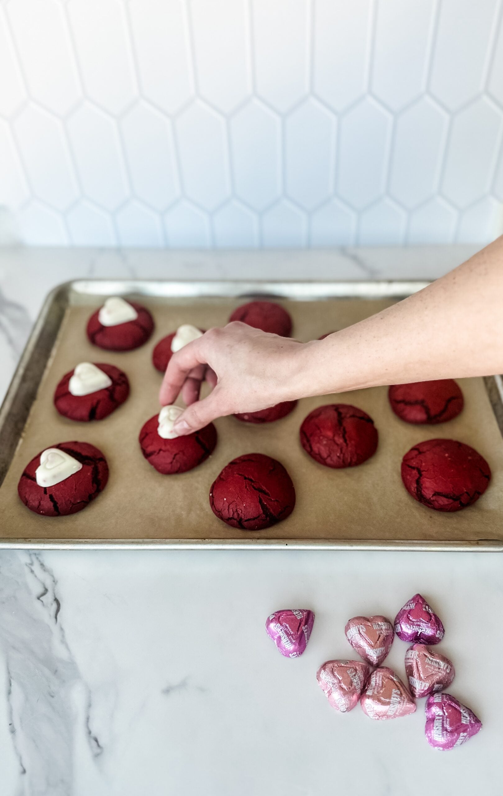making valentines cookies with heart candies 