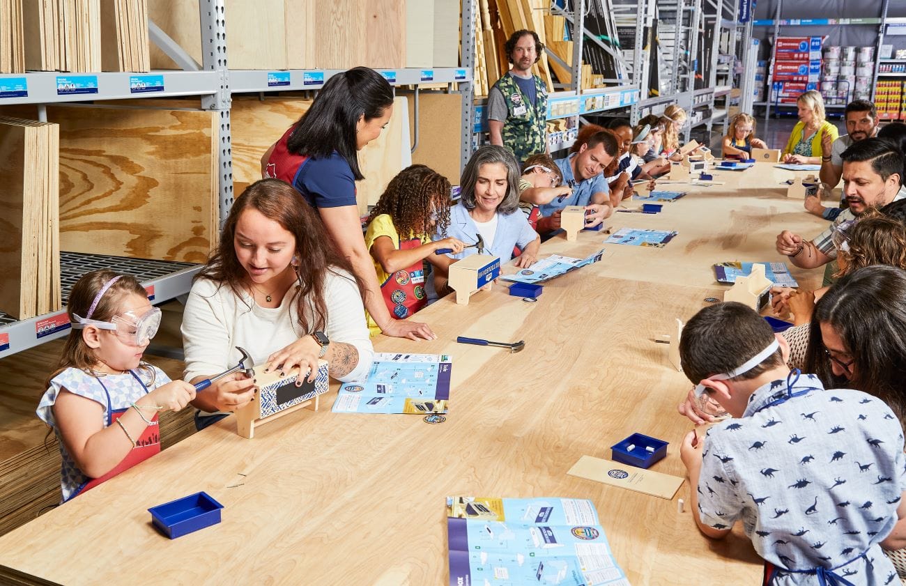 lowe's kids workshops children sitting at wooden table completing tool crafts 