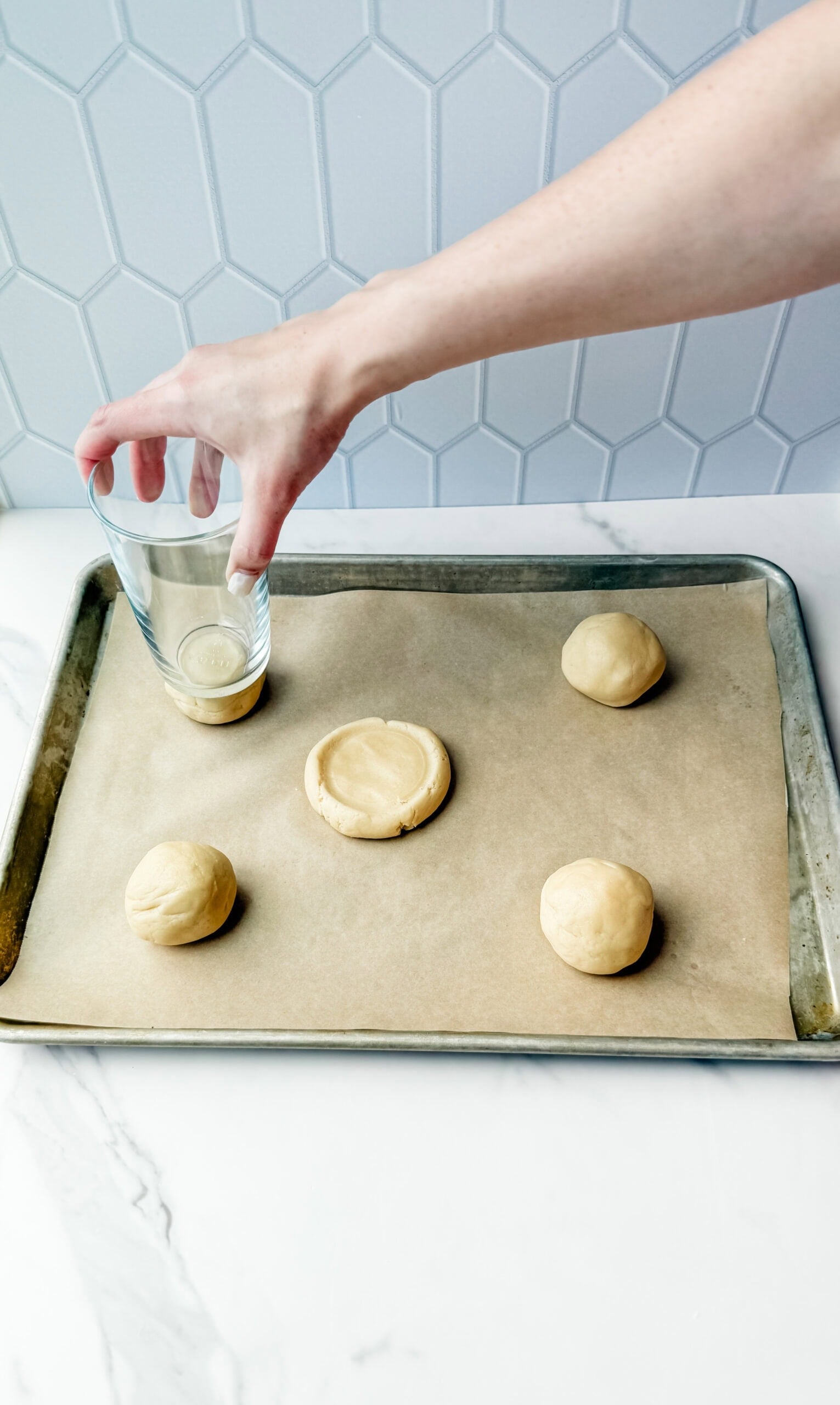 using a glass to smash cookies into cumbl shape