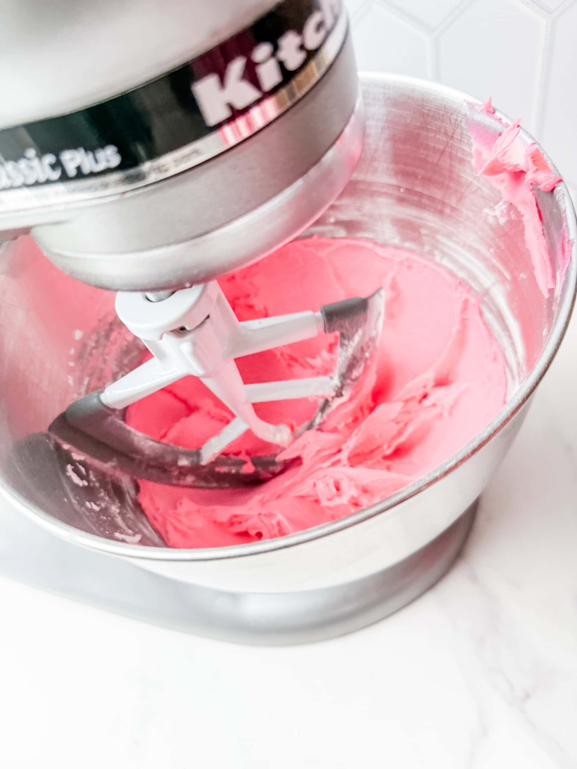 pink frosting in mixing bowl 