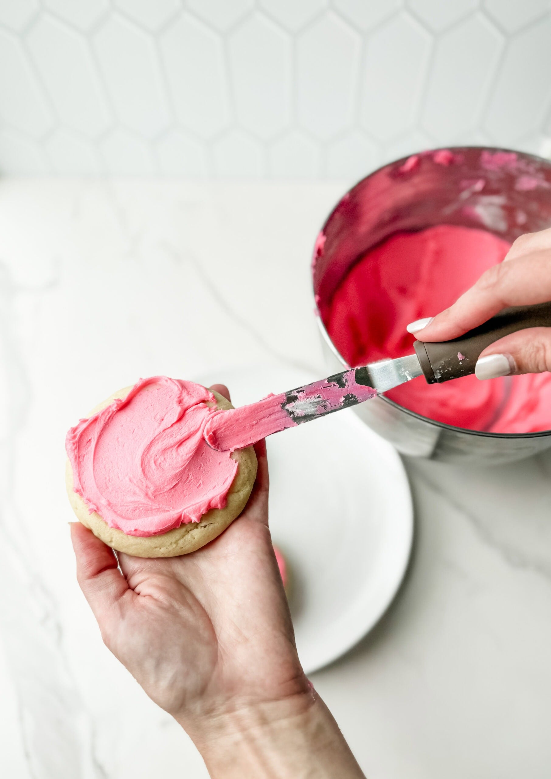 homemade crumbl sugar cookies with pink frosting 