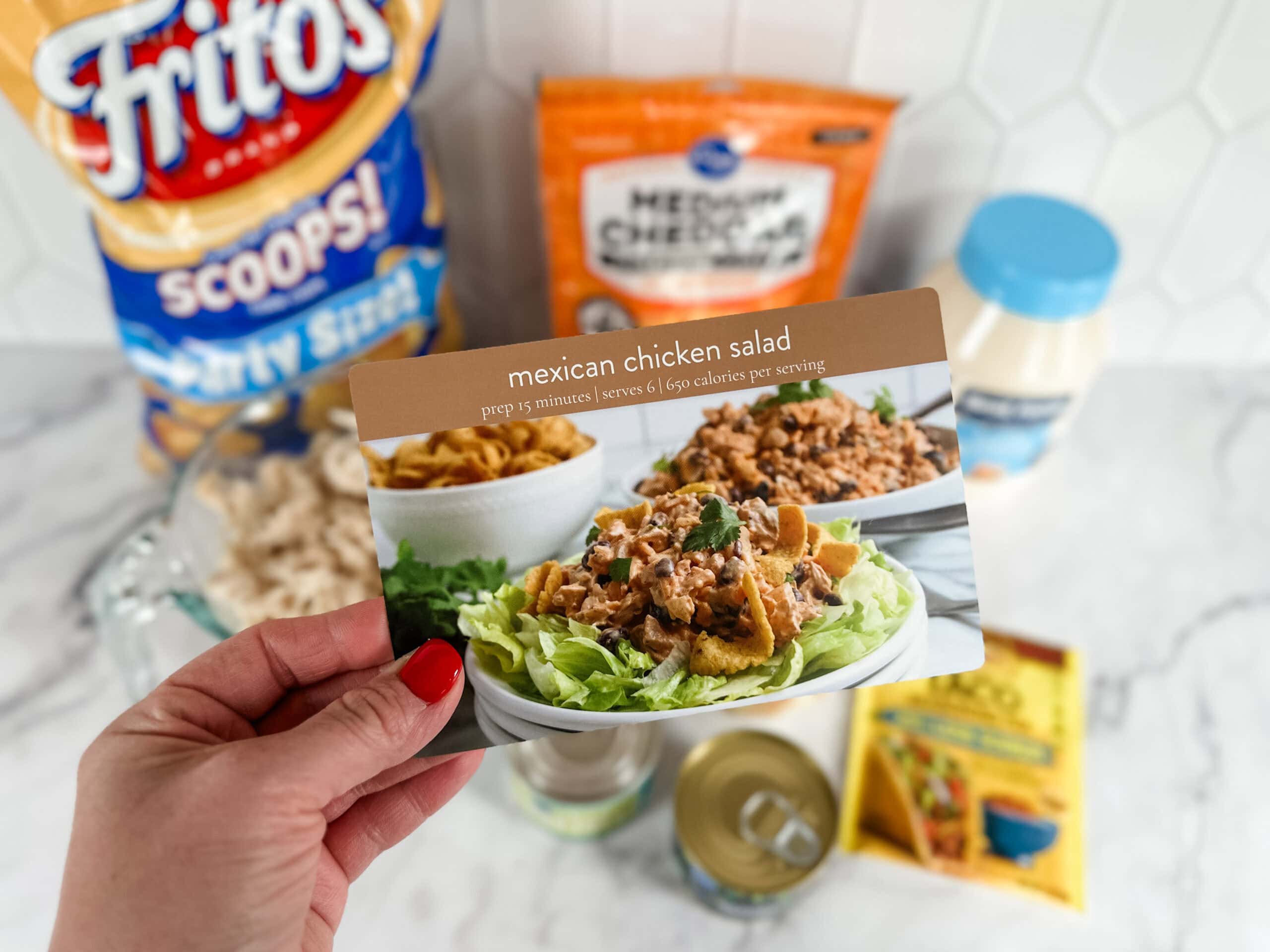 mexican chicken salad recipe card with ingredients in background 