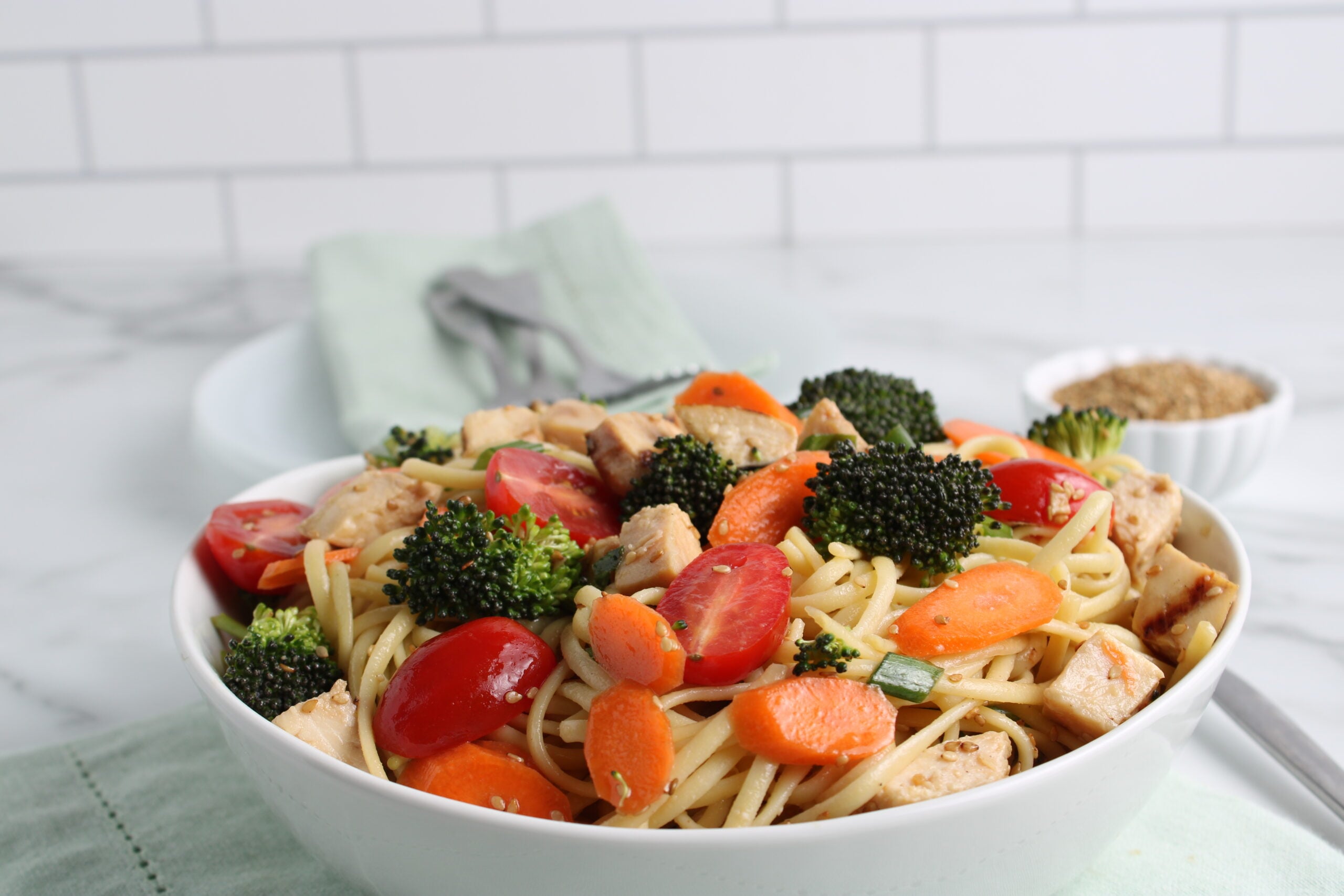 sasame pasta salad in white bowl