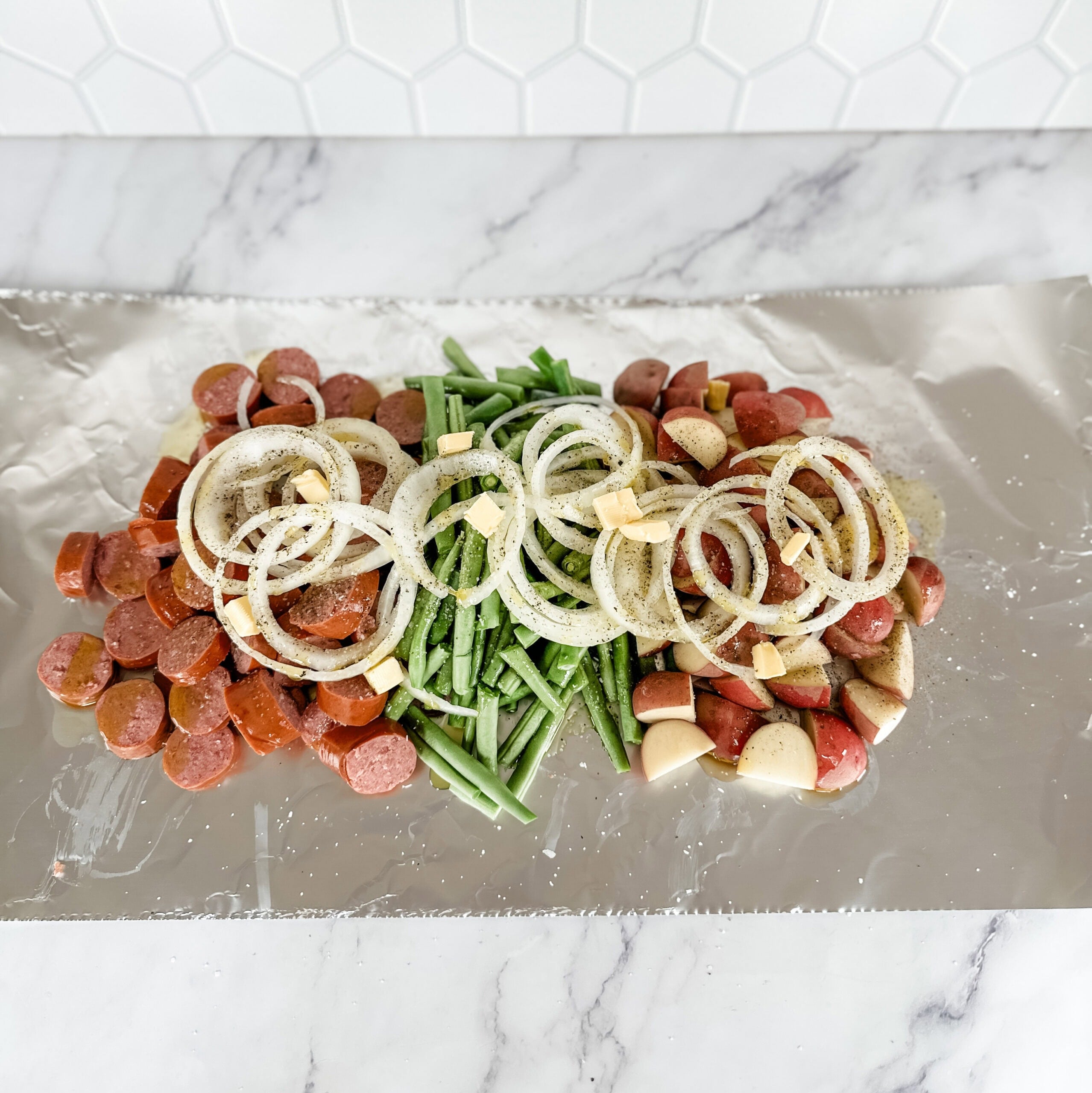 grilled sausage and vegetables on aluminum foil 